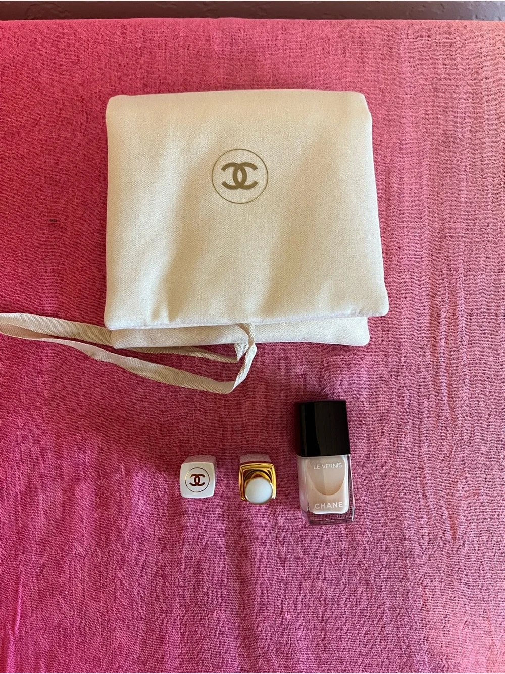 CHANEL Neutral Nail Polish & Branded Bag with Lipstick.